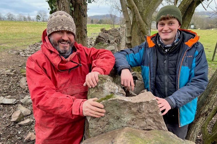 Stonemason Dai Davies and son Hamer with the last section of wall