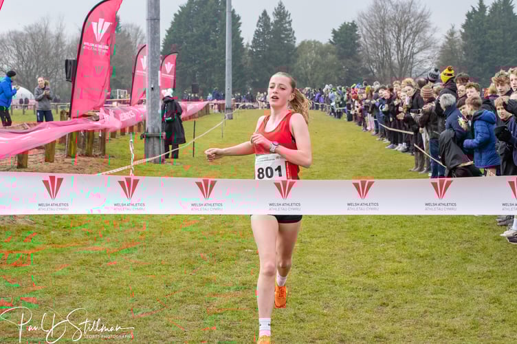 Leah Rhodes crossing the finish line