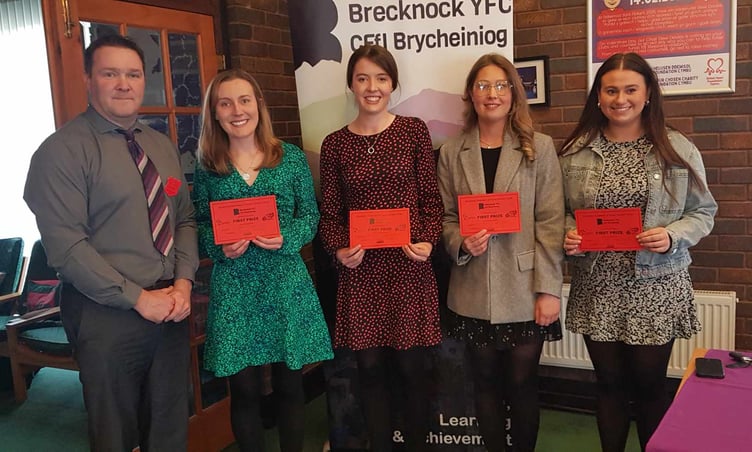 The Senior Welsh Brainstrust team of Sennybridge YFC. Samuel Kurtz MS is presenting the prize