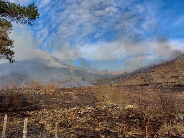 Fire crews are tackling a large grass fire near the A470 in Llanwrthwl