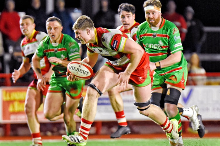 Llandovery flanker Osian Davies on his way to scoring his side's fifth and final try