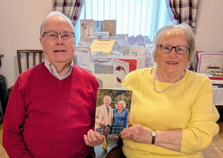 Brian and Mairwen Price with their card from the King and Queen for their 60th Wedding Anniversary