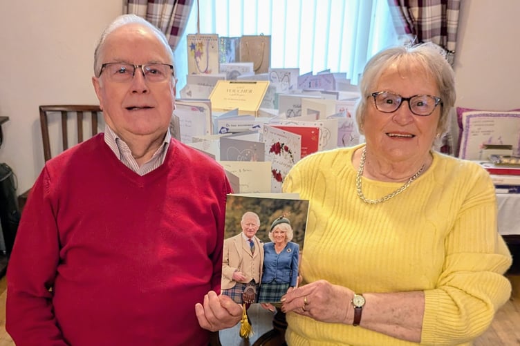 Brian and Mairwen Price with their card from the King and Queen for their 60th Wedding Anniversary