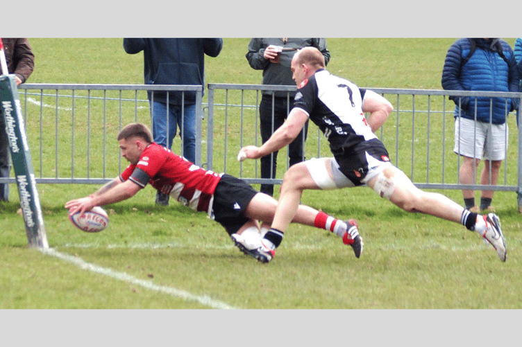 Lewis Jones scores an interception try in spite of Cally James' monumental effort to run him down