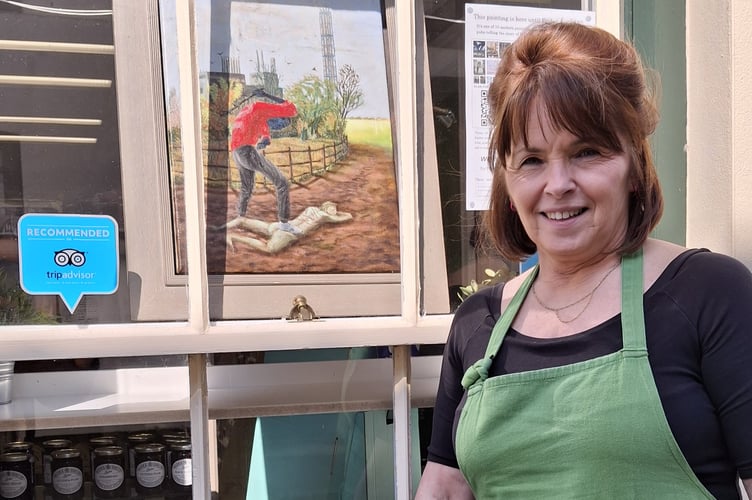 Georgina George with one of the Easter paintings on display at W J George Butchers in Talgarth