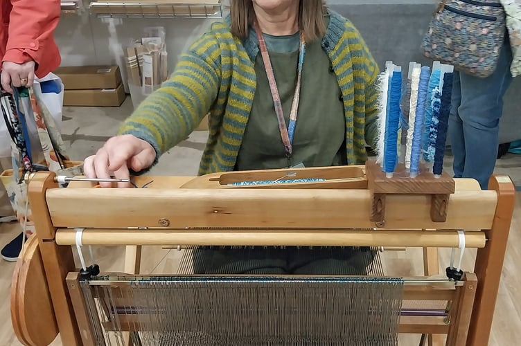 Rosie Green from SAORImor demonstrates weaving at Wonderwool Wales