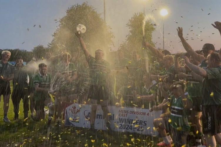 Captain Sam Stephens lifts the league trophy as Gwernyfed celebrate their title win
