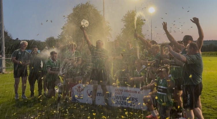 Captain Sam Stephens lifts the league trophy as Gwernyfed celebrate their title win