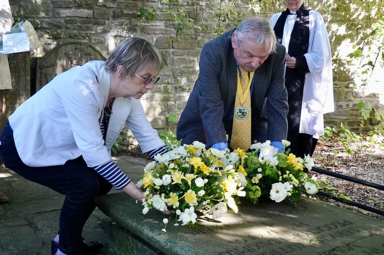 Hilary Davies, Vaughan Association and Nigel Clubb, Brecknock Society lay wreaths at the grave of Henry Vaughan watched by Rev Liz Bramley         