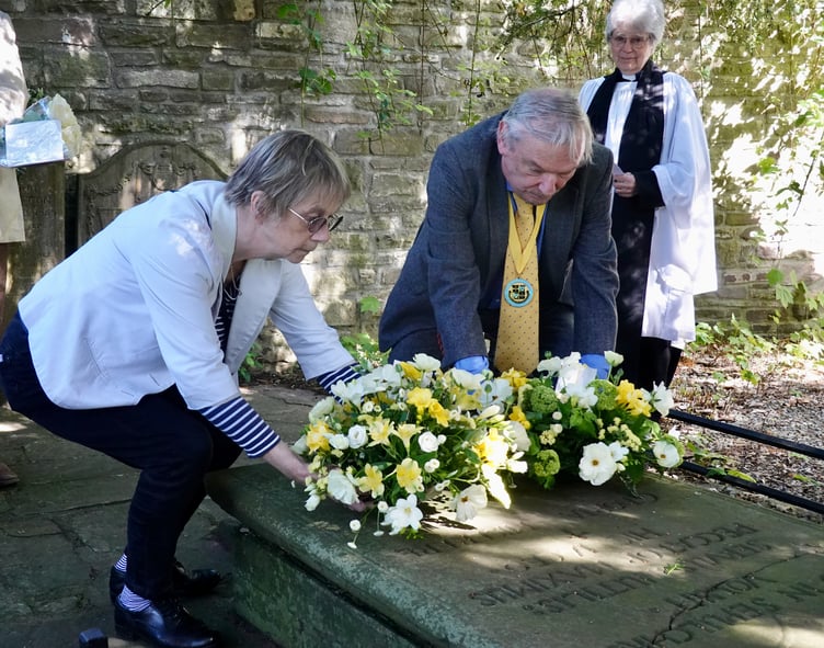 Hilary Davies, Vaughan Association and Nigel Clubb, Brecknock Society lay wreaths at the grave of Henry Vaughan watched by Rev Liz Bramley