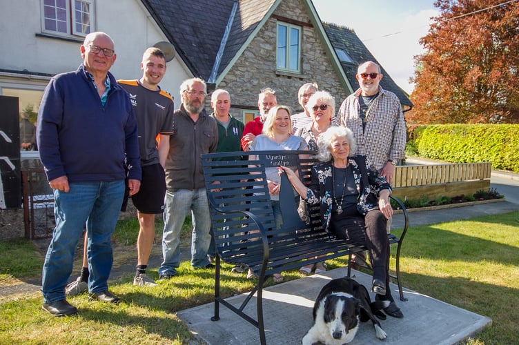 Tania Szabo sits on the newly unveiled 'Cilmery Bench,' alongside members of the community, as part of the village's VE Day 80 commemorations