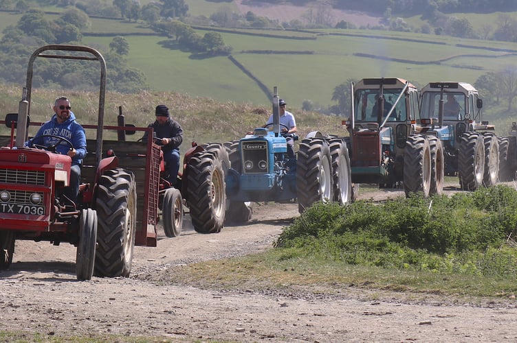 The fleet of Martyn Nicholls tractors, with friend Graham Jones and family in the transport box leading the way
