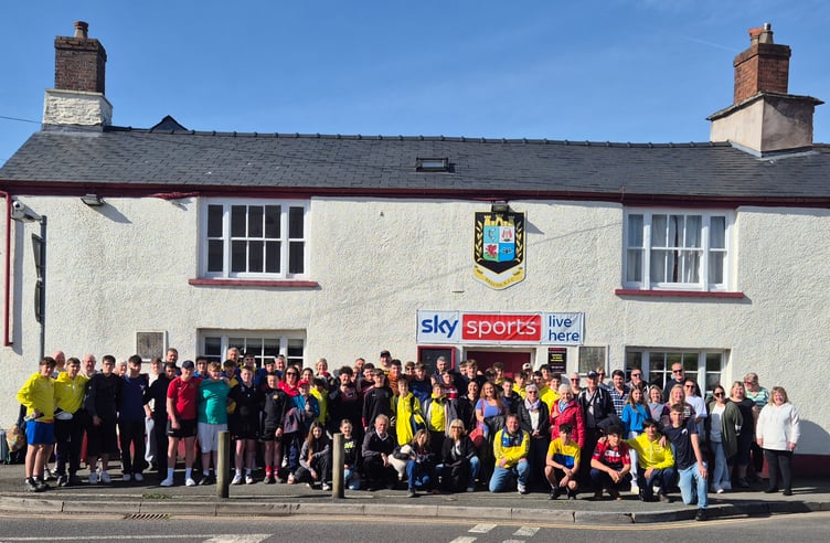 Guests and hosts gather outside Brecon Rugby Club for a farewell photo before departure