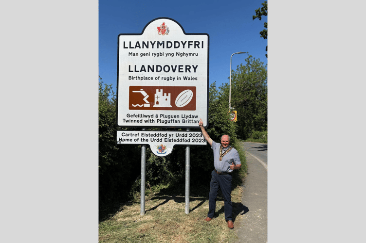 Cllr Handel Davies pictured beside the new sign recognising Llandovery as a birthplace of rugby in Wales