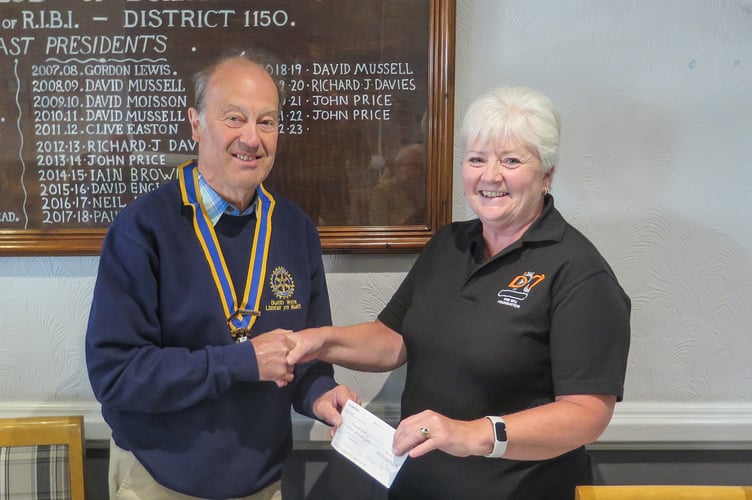 Builth Wells Rotary President, Robert Evans presenting cheque to Amanda Thomas, DPJ Foundation representative