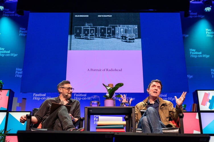 Radiohead bassist Colin Greenwood speaks to scientist Adam Rutherford about his upcoming book, How to Disappear: A Portrait of Radiohead at the 2025 Hay Festival. Credit: Adam Tatton-Reid and Hay Festival.