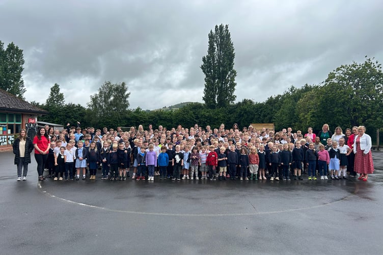Pupils and staff at Llanfaes Primary School celebrate their outstanding Estyn report