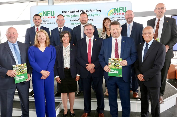 Members of the Senedd with NFU Cymru President Aled Jones, NFU Cymru Deputy President Abi Reader and dairy farmer Delyth Robinson