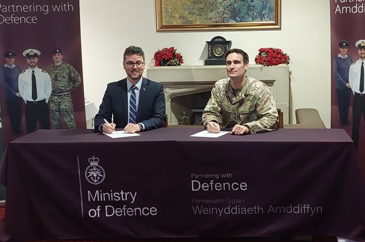 Cllr Matthew Dorrance signing the Armed Forces Covenant in 2023, which renewed the council’s pledge to support Armed forces personnel and their families living in Powys