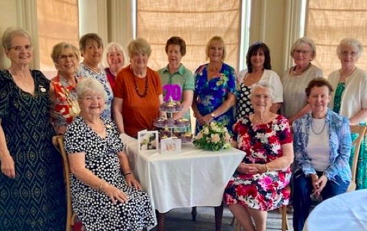 Members of the Brecon Floral Society gathered at Peterstone Court to celebrate the group’s 70th anniversary, joined by committee members and special guests