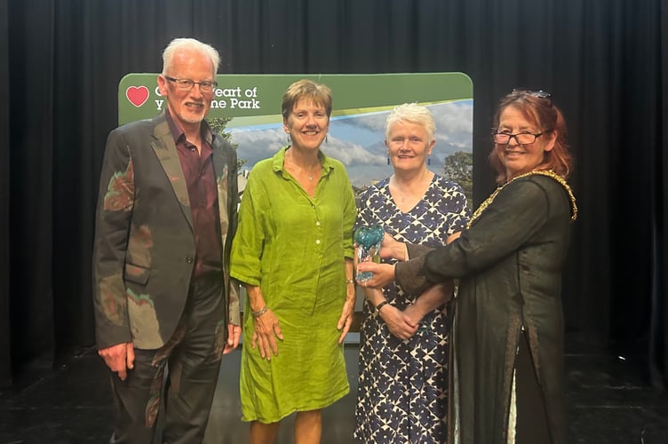 Cllr Marie Matthews presents the Voluntary Group of Team of the Year award to representatives of Hay, Brecon and Talgarth Sanctuary for Refugees (HBTSR)