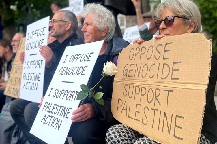 Angie Zelter, second from right, from Powys was arrested by Metropolitan Police following a protest with the group Defend Our Juries, which saw her and other campaigners sitting by the statue of Gandhi, holding home made signs that read: “I oppose genocide. I support Palestine Action.”