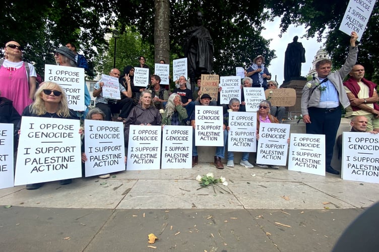 A peace campaigner from Powys was one of 27 people, including a priest, an Emeritus Professor, a former government lawyer and a number of health professionals, to have been arrested in Parliament Square for offences under the Terrorism Act on Saturday.