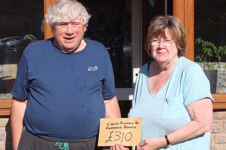 John Bates presents Liz Lewis of the Rhayader Branch of Cancer Research UK with their donation