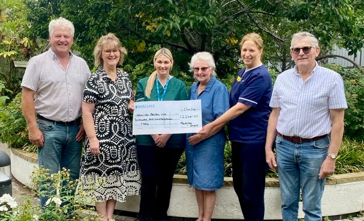 Presenting the cheque with funds raised from the Dolau concert. Left to right: David Lewis, Heather Lewis, staff member Danielle Williams, patient Joe Gayther, senior sister Hannah Linton, and Phil Gayther representing Rhayader and District Male Voice Choir