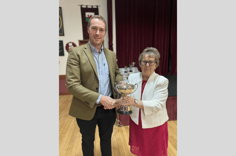 Champion solo winner Ilan Jones receives the John Robinson Cup from Mary Robinson