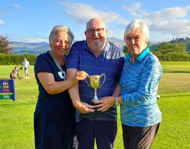 Ladies Captain Diane Davies presents the winners’ trophy to Andy Black and Brian Evans at Cradoc Golf Club’s mixed open competition