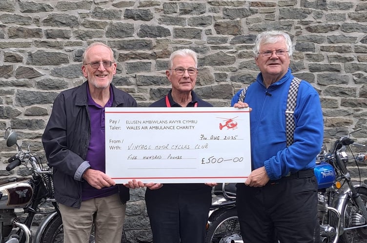 Builth resident Gary Jones and VMCC President Elect Roger Bibbings MBE standing either side of local Wales Air Ambulance representative Brian Tolley