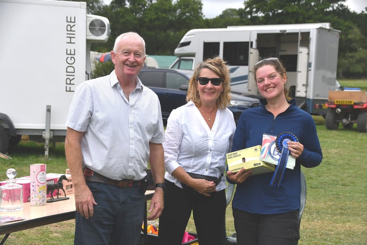 Emily Ham receives her Reserve National Champion award from National Championship hostess Jane Robinson and FEI dressage judge James Rooney at Glebe House, West Grinstead