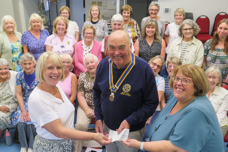 Receiving the cheque from Hugh Garner, Rotary President, was Yonwyn Davies, musical director and Trish Thomas, secretary