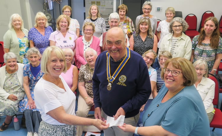 Receiving the cheque from Hugh Garner, Rotary President, was Yonwyn Davies, musical director and Trish Thomas, secretary