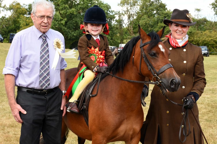 Champion in the ridden section went to five-year-old Frankie Phillips. She is pictured with mum Sarah and show President Arwyn Richards