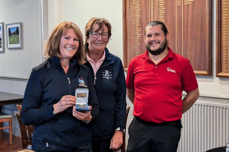 Cath Maggs receives her medal from a Wales Golf official and Creigiau’s Lady Captain in recognition of her top individual score