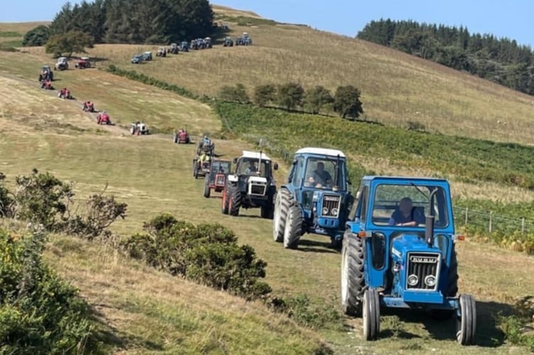 The convoy of tractors weaving their way down off the hilltop