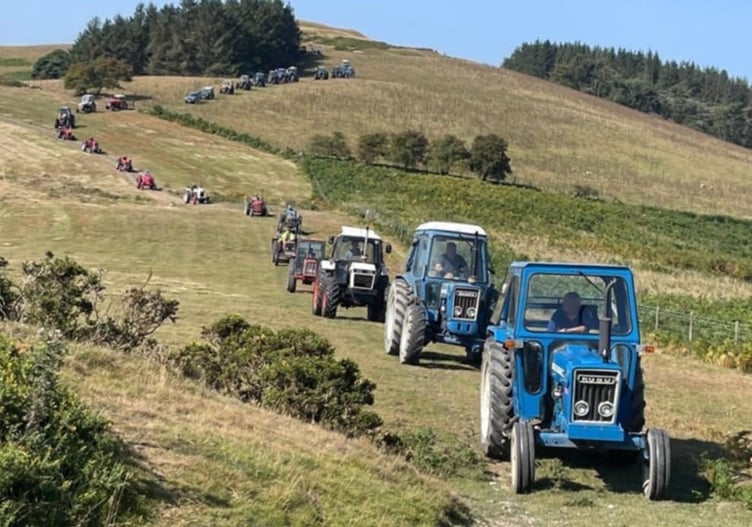 The convoy of tractors weaving their way down off the hilltop