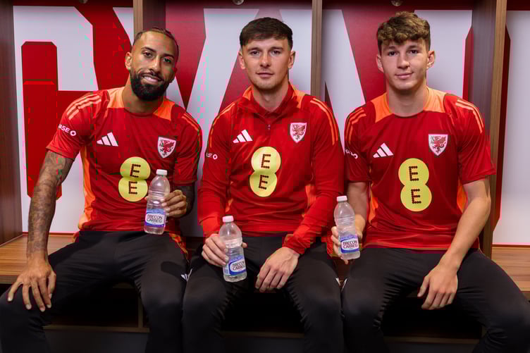 PONTYCLUN, WALES - 01 SEPTEMBER 2025: Wales' Sorba Thomas, Wales' Mark Harris and Wales' Lewis Koumas pose with a Brecon Carreg water bottle during a media session at the Vale Resort ahead of the 2026 FIFA World Cup European Qualifiers fixture against Kazakhstan on the 4th of September at the Astana Arena, Kazakhstan (Pic by John Smith/FAW)