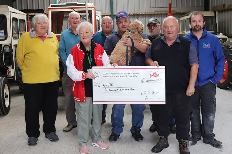 Ann Evans of Wales Air Ambulance receives a cheque from the tractor run proceeds