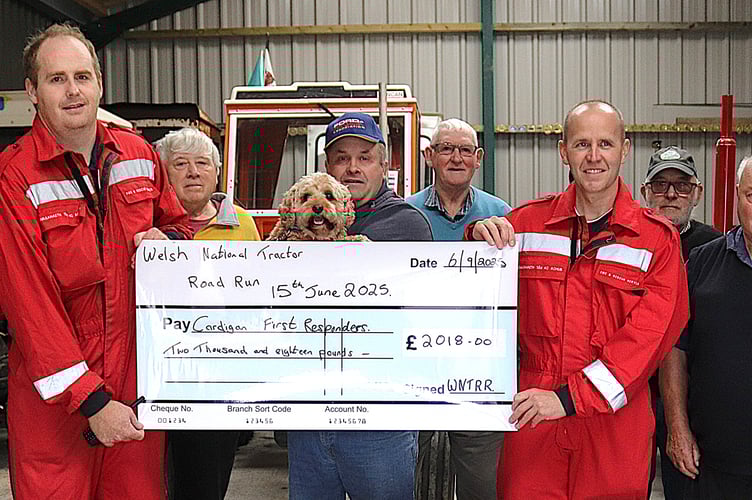 Jason Davies and Gareth Hands from Cardigan First Responders receiving their cheque