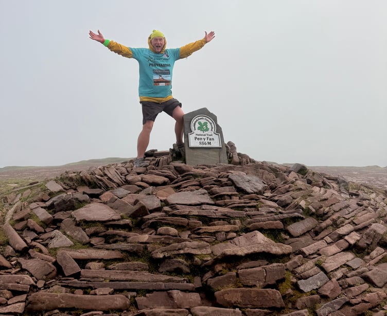 Chris Daniel has celebrated his record-breaking 366th climb of Pen y Fan, raising thousands for Bowel Cancer UK in memory of his late wife, Rita