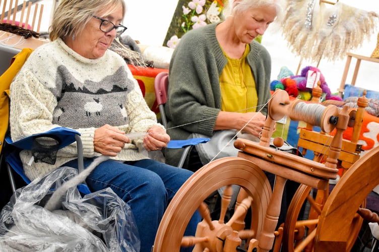 Two members of the Carmarthen Spinners, Weavers and Dyers in action