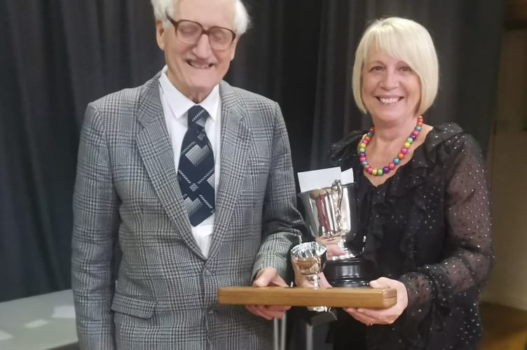 Ionwen Davies, conductor of Builth Wells Ladies Choir, receiving the cup for winning the choir competition, from Hywel Davies, Chairman of Llanwrtyd Eisteddfod