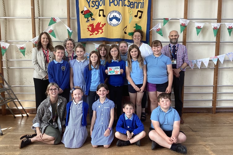 Members of Ysgol Pontsenni Criw Cymraeg, with their Silver Award, together with Miss K. Harry (Headteacher) and Criw Cymraeg Coordinators, Mr C.W. Price (Deputy Headteacher) and Mrs R. Wilbur