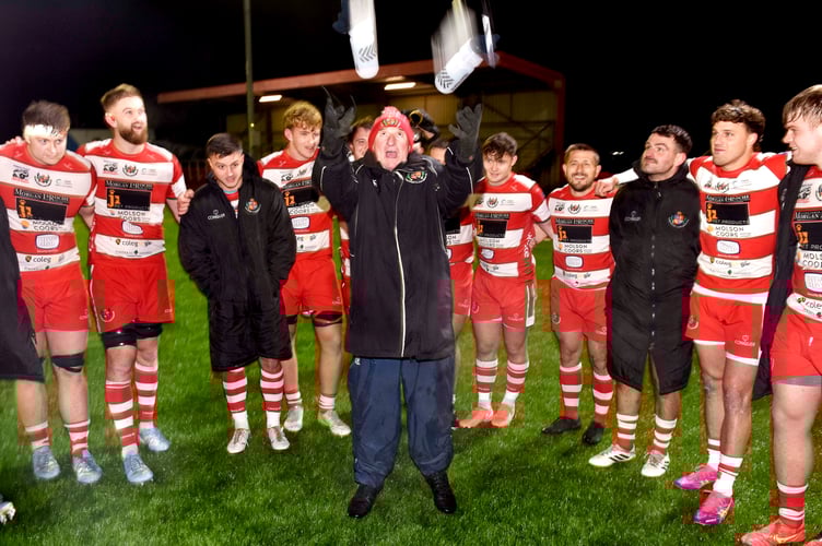 Llandovery celebrate their win with their traditional post match team huddle