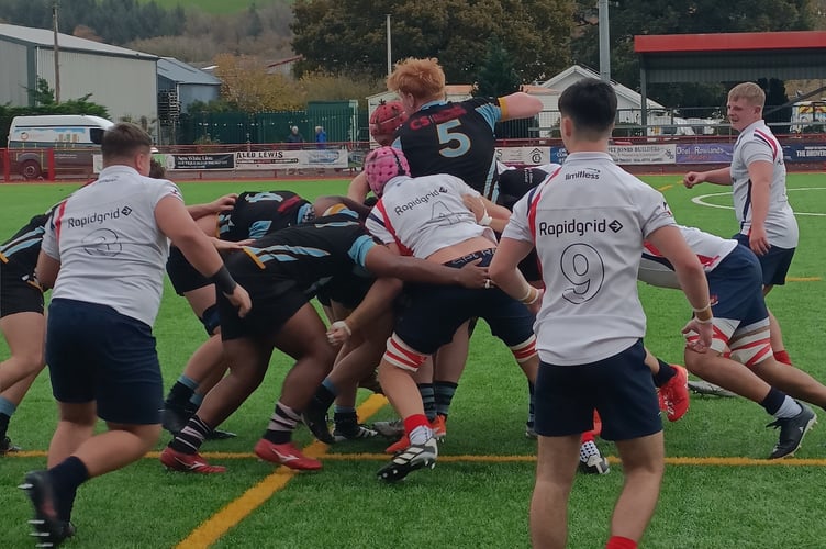 Llandovery scrum-half Louis Cooper (9), son of former Wales and Lions scrum-half Gareth Cooper, watches as Whitchurch lock Sonny McCabe disrupts the Llandovery maul