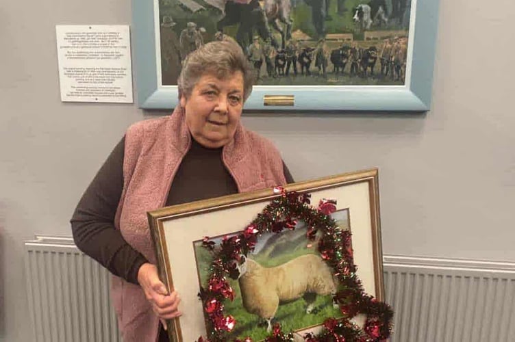 Pam Chilman with a painting of her prize-winning Kerry Hill ram lamb, marking her retirement