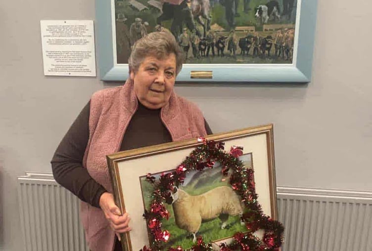 Pam Chilman with a painting of her prize-winning Kerry Hill ram lamb, marking her retirement
